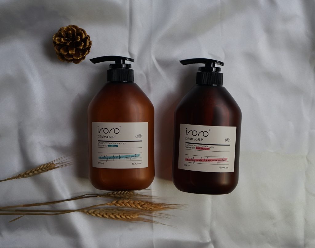 two bottles of shampoo and a pine cone